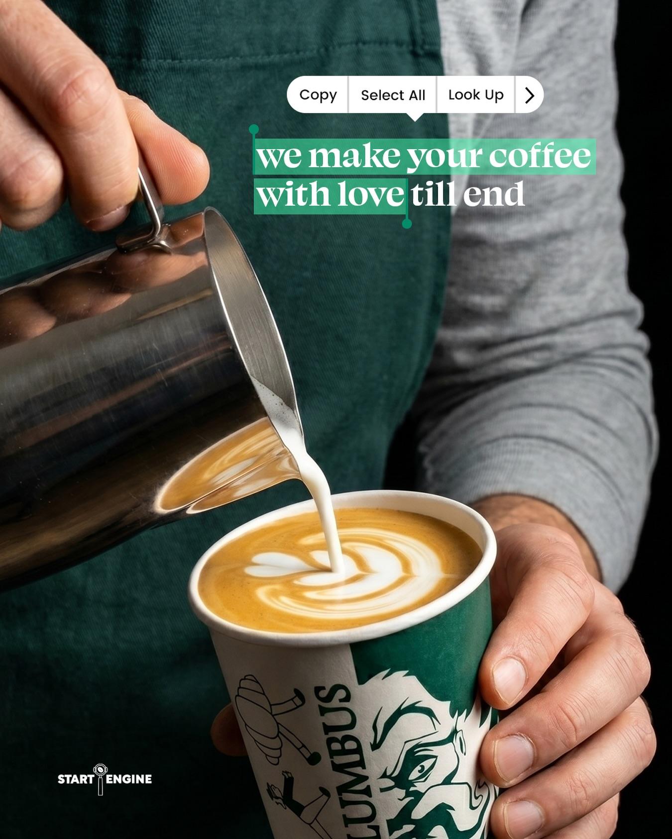A Columbus barista pouring latte art into a branded cup